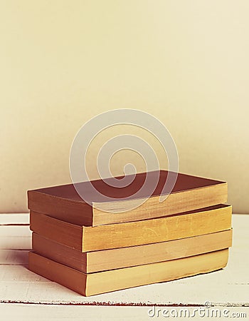 Vintage novel paperback books on wooden table. Copy space. Vertical image. Retro Stock Photo