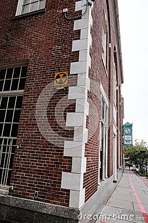 Vintage nuclear fallout sign seen fixed to a building in a US eastern town. Editorial Stock Photo