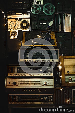 Vintage old design boombox radio cassette tape recorders and audio old music player ussr. Vintage style photo background. Vertical Editorial Stock Photo