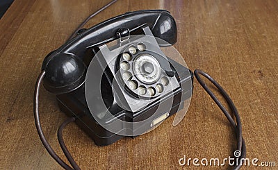 Vintage old telephone on wooden desk. technology of yesteryear Stock Photo