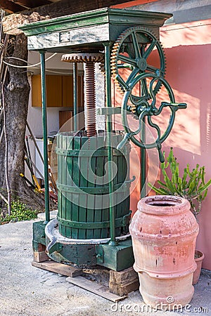 Vintage olive press with wooden barrel terracotta jar Stock Photo