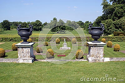 Vintage ornaments on pedestals in a topiary garden Stock Photo