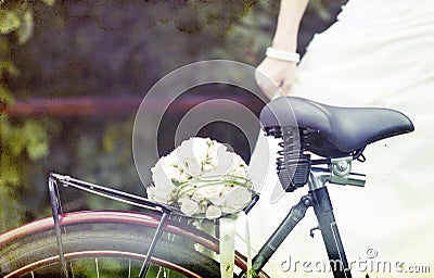 Vintage photo of bride and wedding bouquet on a bicycle Stock Photo