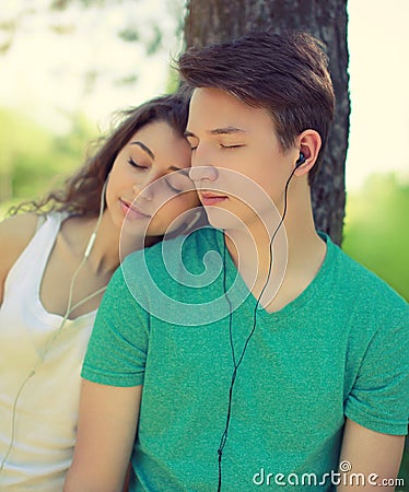 Vintage photo couple guy and girl in headphones enjoying music Stock Photo