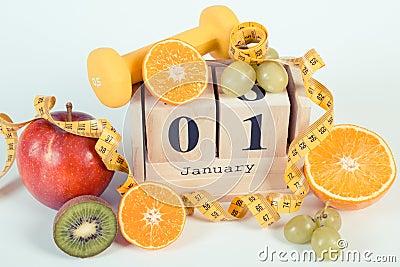 Vintage photo, Cube calendar, fruits, dumbbells and tape measure, new years resolutions Stock Photo