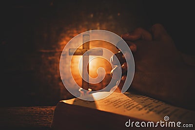 Vintage photo of hand with Bible praying , Hands folded in prayer on a Holy Bible , Stock Photo