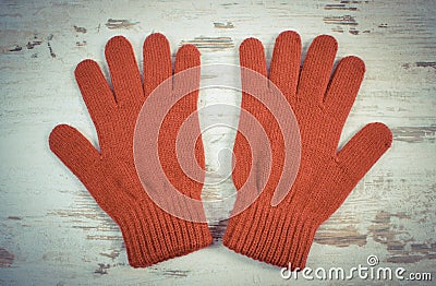 Vintage photo, Pair of woolen gloves for woman on old wooden background Stock Photo