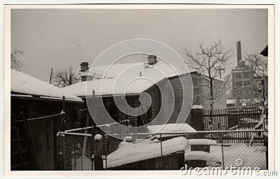 Vintage photo shows the house and the backyard in winter time. Retro black and white photography. Circa 1950s Editorial Stock Photo
