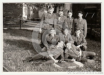 Vintage photo shows soldiers pose in front of barracks. Black and white antique photo. Editorial Stock Photo