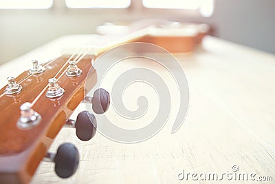 Acoustic guitar strings on wooden table in the room, close up top view and sunlight with empty space for you text Stock Photo