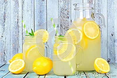 Vintage pitcher of lemonade with mason jar glasses on rustic blue wood Stock Photo