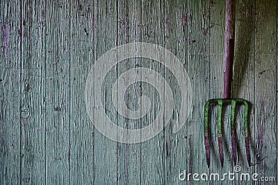 Vintage pitchfork on green used wood Stock Photo