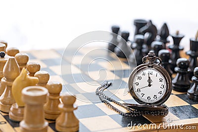 Vintage pocket watch and chess pieces Stock Photo