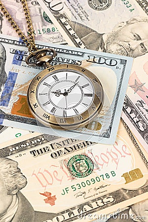 Vintage pocket watch clock on dollar banknote concept for money time value Stock Photo