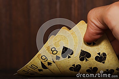 Vintage poker cards holded in a man hand Stock Photo