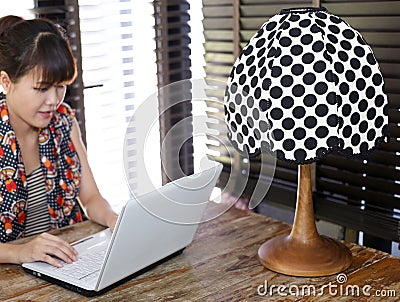 Vintage polka dot lamp with intentionally blurred working woman Stock Photo