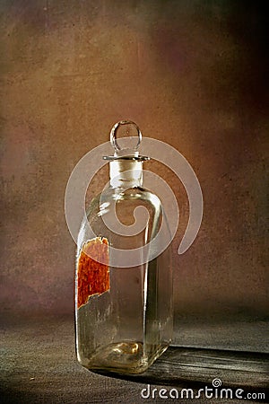 Vintage pontil type bottle on rustic backdrop studio shot Lokgram Stock Photo