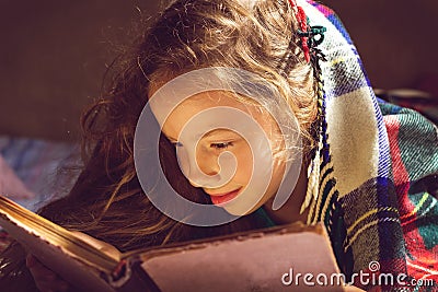 Vintage portrait of cute girl reading a book in cold day Stock Photo