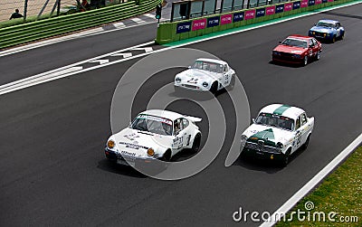 Vintage racing car, classic retro motor sport action, group of cars on asphalt race track Editorial Stock Photo