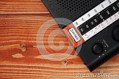 Old radio for listening to radio programs on a wooden background Stock Photo