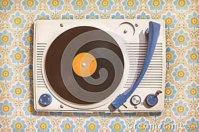 Vintage record player on top of flower wallpaper Stock Photo