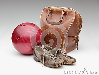 Vintage Red Bowling Ball, Distressed Leather Bag and Brown Shoes Stock Photo