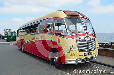 Vintage Red and Cream Bedford Super Vega Coach parked at the seaside. Editorial Stock Photo