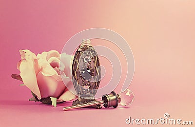 Vintage retro filter perfume bottle with crystal stopper and silk rose Stock Photo