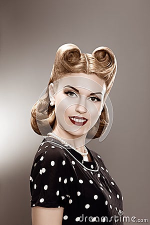 Vintage. Retro Woman in Stylish Polka Dot Dress Portrait - Pin Up Stock Photo