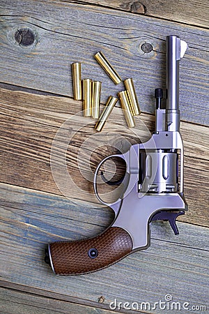 Vintage revolver nagant with a rotating drum and the seven golden cartridges Stock Photo