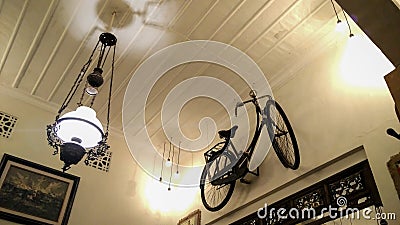 Vintage room with antique chandelier interior with white lamps and old bicycles Editorial Stock Photo