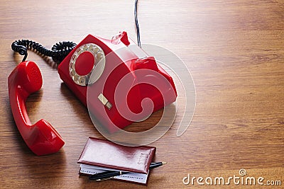 Vintage rotating red disc phone and phone book Stock Photo