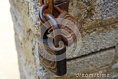 Vintage rusted padlocks on a stone wall in Phong Nha, Vietnam Editorial Stock Photo