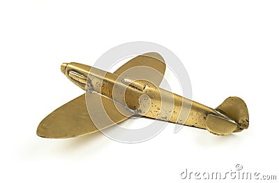 Vintage 1940s brass toy airplane on white background Stock Photo