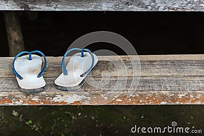 Sandal or flip-flop blue color on wooden staircase Stock Photo