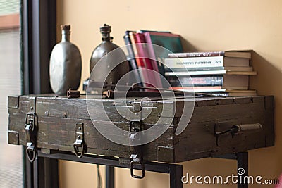 Vintage setup. Creatively made side tabe, old suitcase and metal construction. Stock Photo