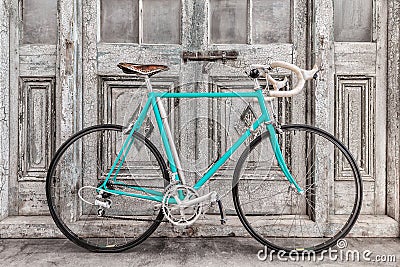 Vintage seventies light blue racing bicycle in front of old black and white wooden doors Stock Photo