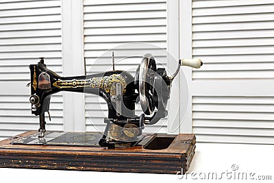 Vintage sewing machine is standing on the white table Editorial Stock Photo