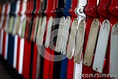 Vintage signal levers all lined up in a preserved heritage railway signal box. Levers are colour coded and numbered Stock Photo