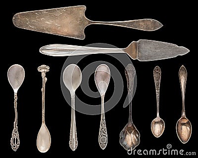 Vintage Silverware, antique spoons, knives, cake shovels isolated on isolated black background. Antique silverware. Retro Stock Photo