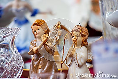 Vintage souvenir angels and porcelain dishes in a market Stock Photo