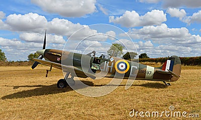 Vintage Spitfire BM597 G-MKVB Mk.Vb static on airstrip with blue sky and clouds. Editorial Stock Photo