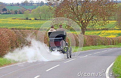 Vintage steam car on a country road. Editorial Stock Photo