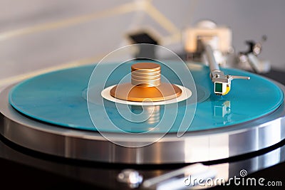 Vintage Stereo Turntable Record Player Tonearm Above Blue Colored Vinyl Stock Photo