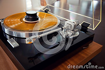 Vintage Stereo Turntable Record Player Tonearm Above Yellow Colored Vinyl Stock Photo
