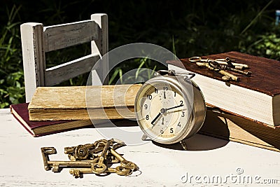 Vintage still life with old alarm clock, keys and books Stock Photo