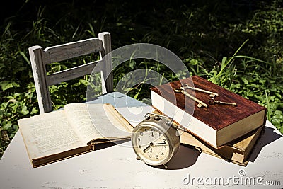 Vintage still life with old alarm clock, keys and books Stock Photo