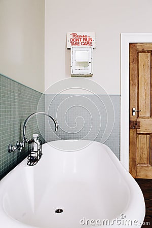 Vintage style bathroom with quirky retro safety sign Stock Photo