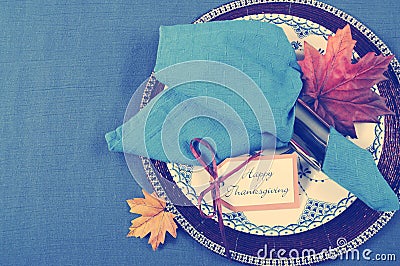 Vintage style Happy Thanksgiving dining table place setting with retro filter Stock Photo