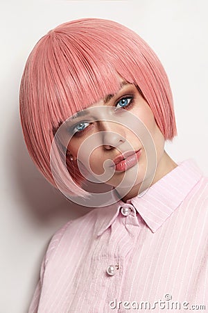 Vintage style portrait of beautiful woman in fancy pink wig Stock Photo